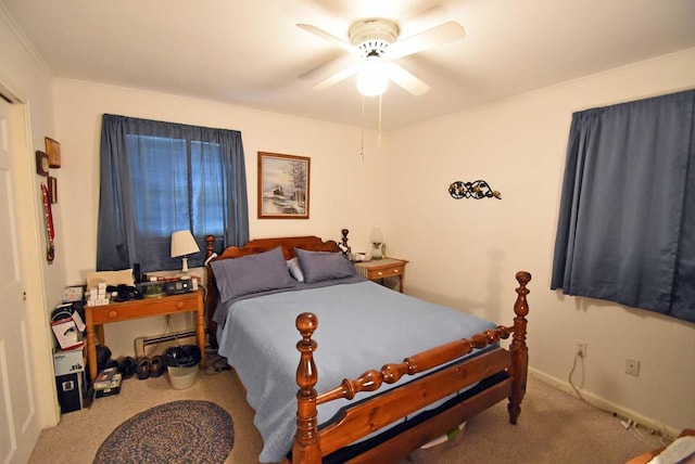 carpeted bedroom featuring ceiling fan and a baseboard radiator