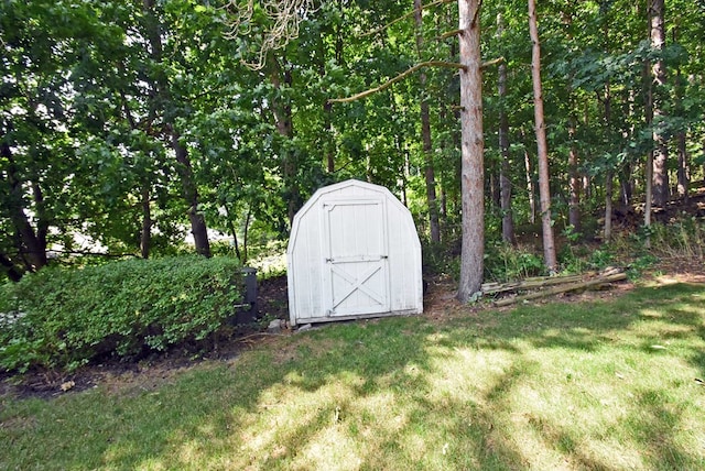 view of outbuilding with a lawn