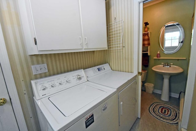 laundry room featuring cabinets, washer and dryer, and sink