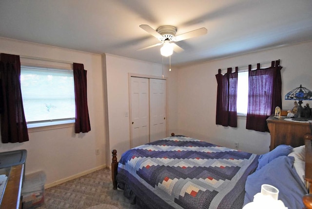 carpeted bedroom with multiple windows, a closet, and ceiling fan