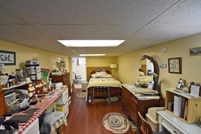 bedroom featuring dark hardwood / wood-style flooring and a drop ceiling