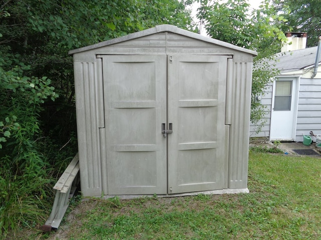 view of outdoor structure with a lawn