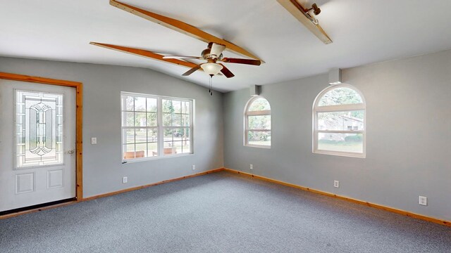 entrance foyer featuring ceiling fan, vaulted ceiling, plenty of natural light, and carpet flooring