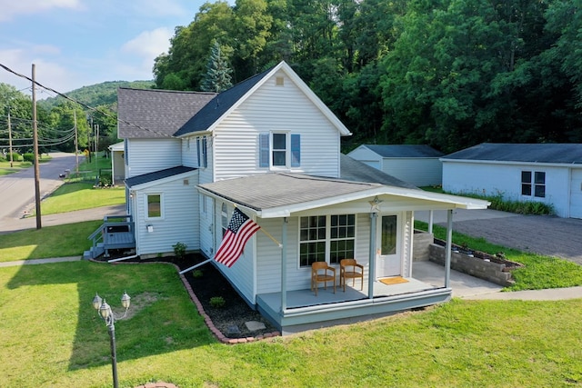 rear view of property with a yard and covered porch