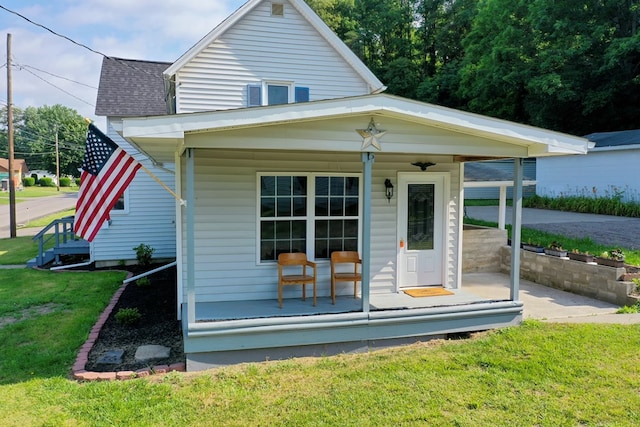 exterior space featuring a yard and covered porch