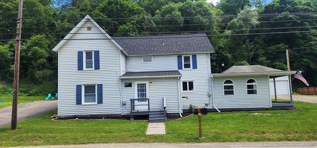 back of property with a lawn