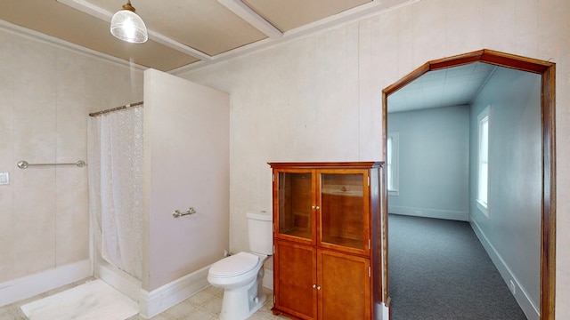 bathroom featuring curtained shower and toilet