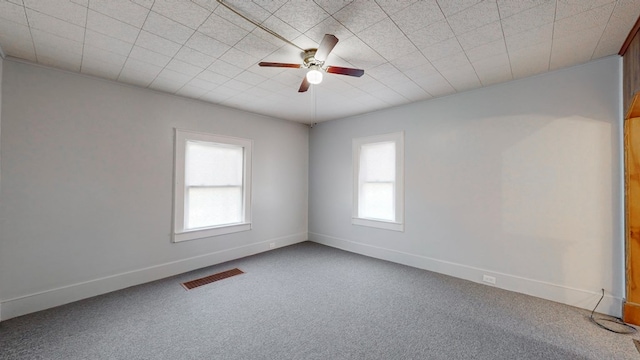 empty room featuring carpet floors and ceiling fan