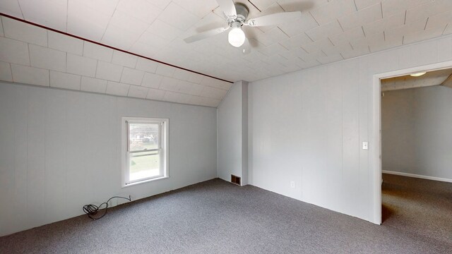 unfurnished room with vaulted ceiling, ceiling fan, and carpet floors