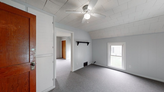 carpeted empty room with ceiling fan and lofted ceiling