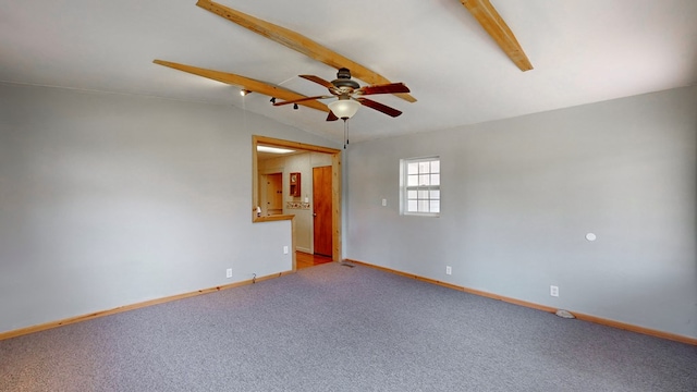 empty room featuring carpet floors, vaulted ceiling, and ceiling fan