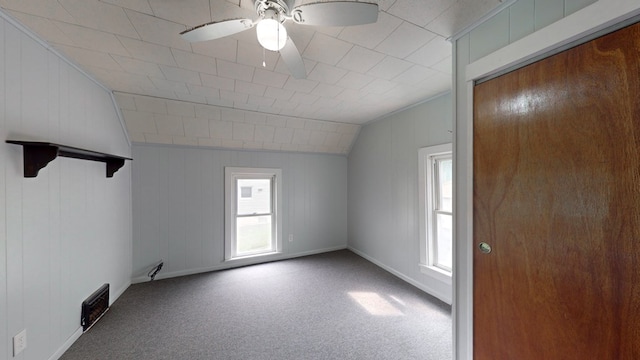 interior space featuring vaulted ceiling, ceiling fan, and carpet