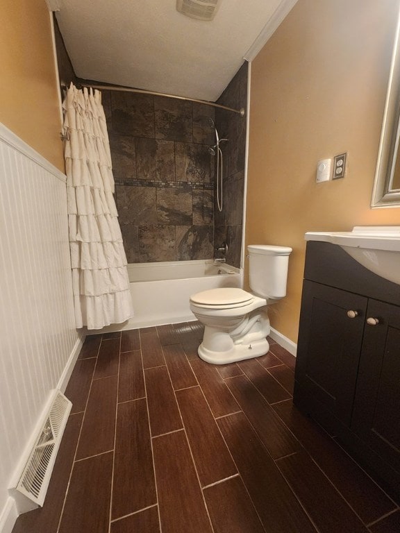 full bathroom with shower / tub combo with curtain, vanity, and toilet