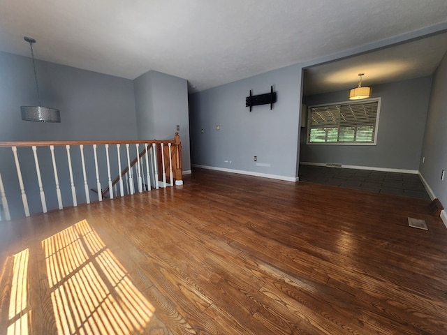 empty room with dark hardwood / wood-style floors