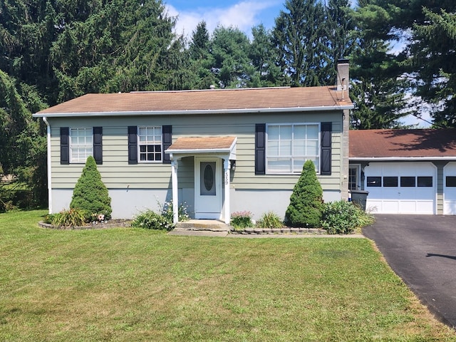 bi-level home featuring a garage and a front yard