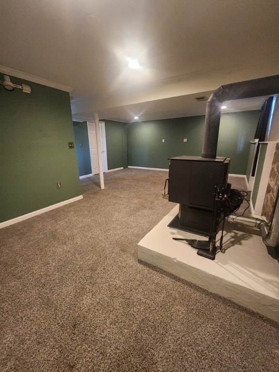 basement with carpet and a wood stove