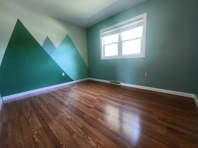 empty room with dark wood-type flooring