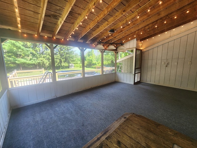 unfurnished sunroom featuring wood ceiling