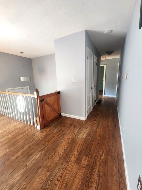 corridor featuring dark hardwood / wood-style floors