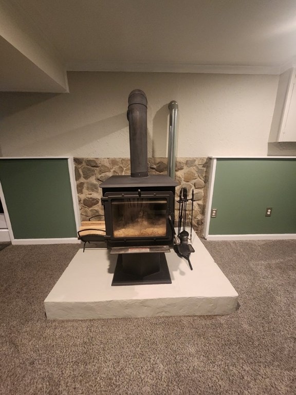 details featuring ornamental molding, carpet flooring, and a wood stove