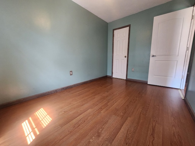 unfurnished bedroom with wood-type flooring