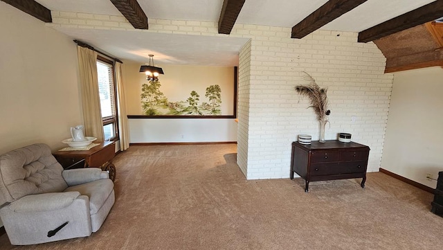 sitting room featuring beamed ceiling, brick wall, and carpet flooring