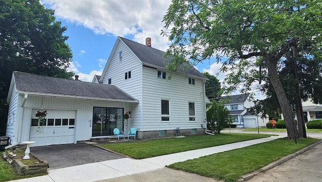 view of front of property featuring a garage and a front lawn