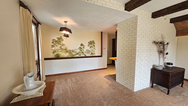 hall featuring light colored carpet, beamed ceiling, and brick wall