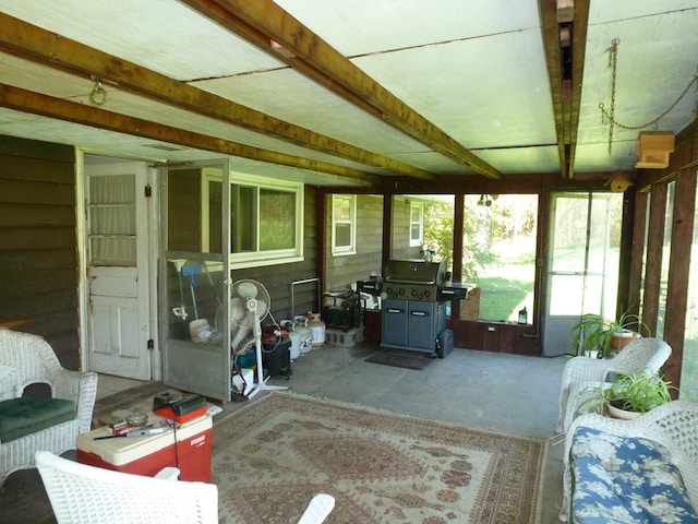 sunroom featuring beam ceiling