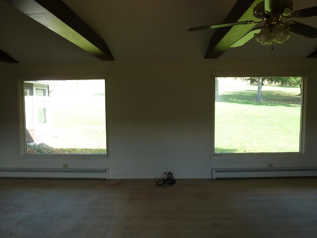 carpeted empty room featuring plenty of natural light, a baseboard heating unit, and vaulted ceiling with beams