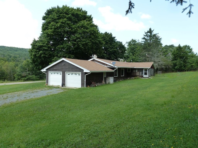 ranch-style house featuring a garage and a front yard