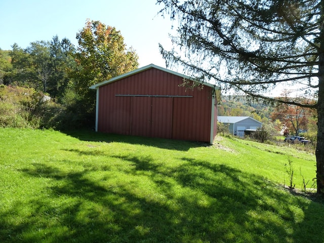 view of outbuilding featuring a lawn