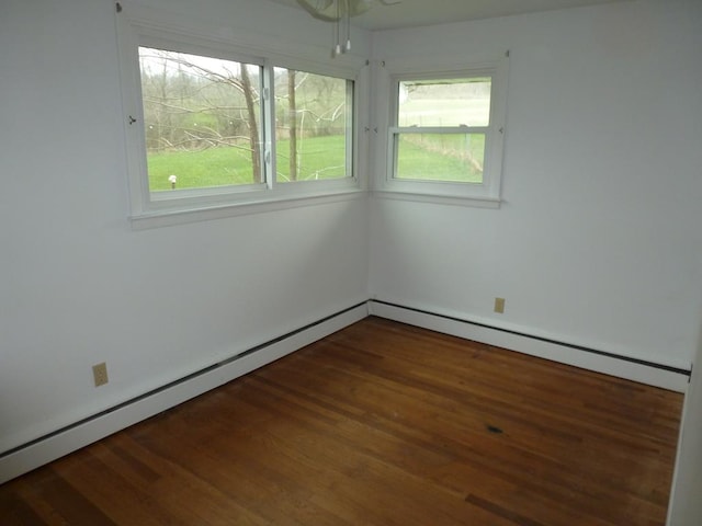 empty room with dark hardwood / wood-style flooring