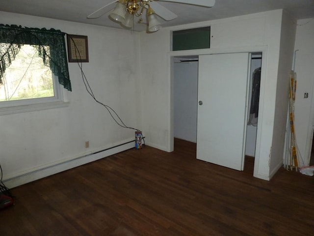 unfurnished bedroom featuring ceiling fan, a baseboard radiator, dark hardwood / wood-style flooring, and a closet