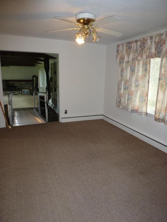 spare room featuring ceiling fan and carpet