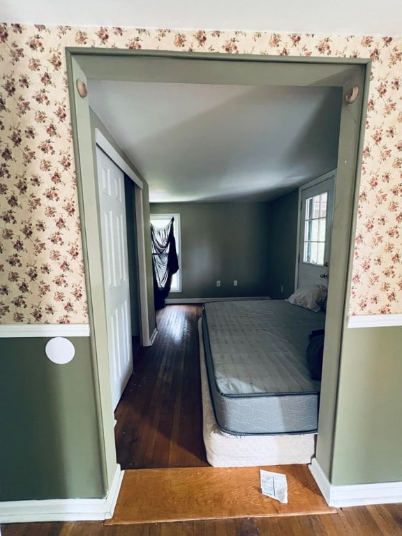 bedroom with wood-type flooring and a closet