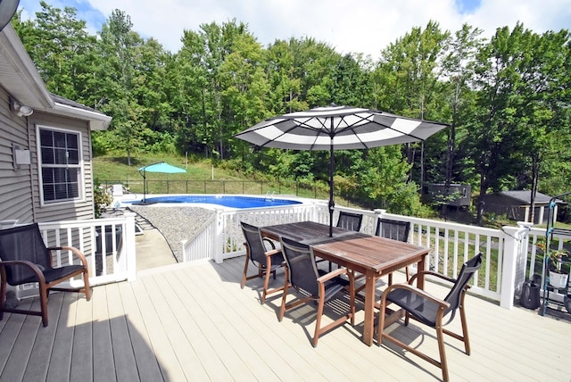 wooden terrace with a fenced in pool