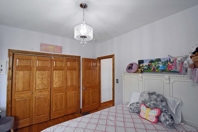 bedroom featuring wood-type flooring and a chandelier