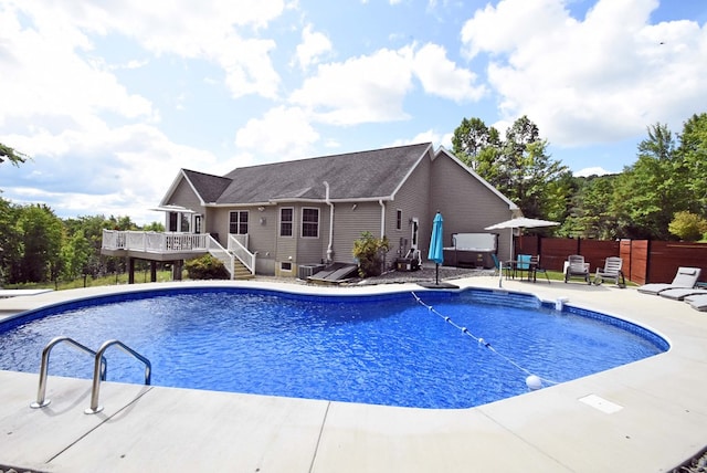 view of swimming pool with a wooden deck