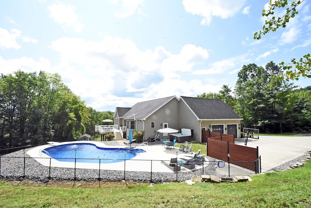 view of swimming pool with a patio and a deck