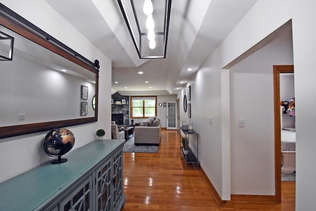 hall featuring a barn door and dark hardwood / wood-style floors