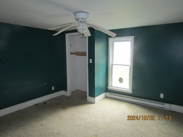 unfurnished bedroom featuring a baseboard radiator, light carpet, and ceiling fan