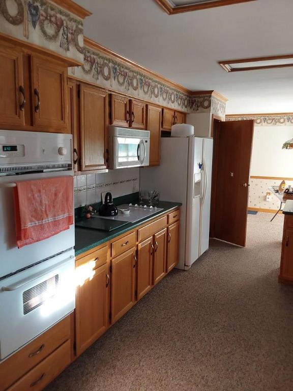 kitchen with crown molding, white appliances, and decorative backsplash