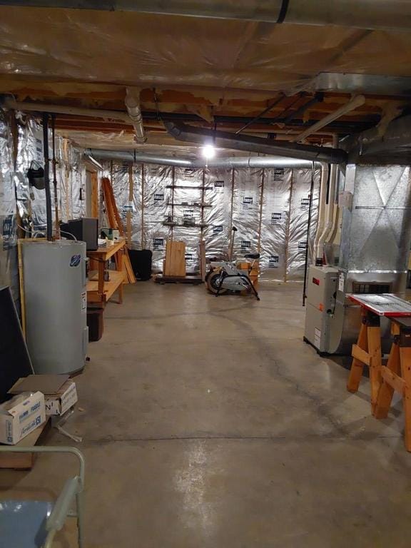 basement featuring electric water heater and heating unit