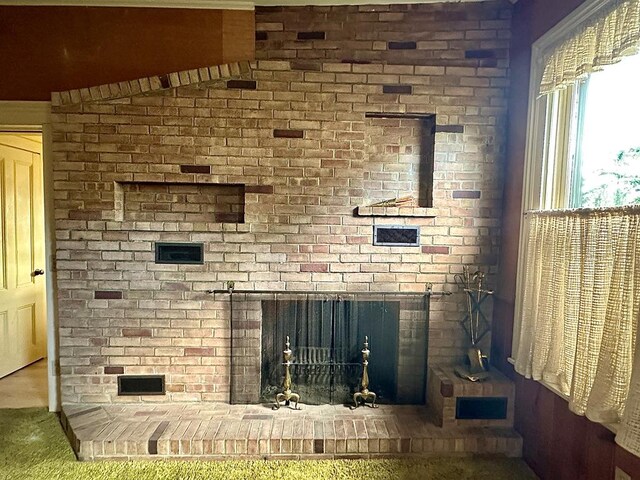 interior details featuring a brick fireplace