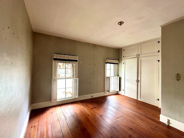 spare room with hardwood / wood-style floors