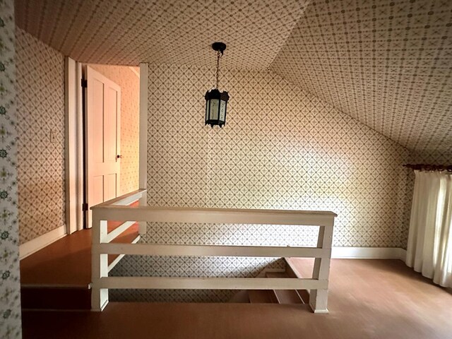 stairs featuring vaulted ceiling