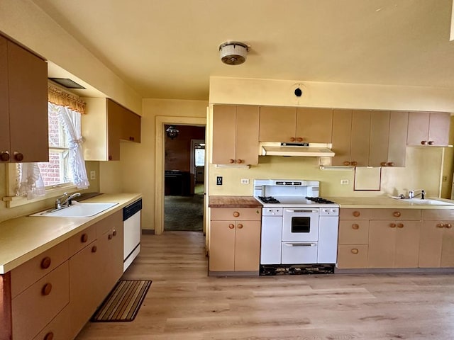 kitchen with sink, light hardwood / wood-style flooring, dishwasher, double oven range, and cream cabinetry