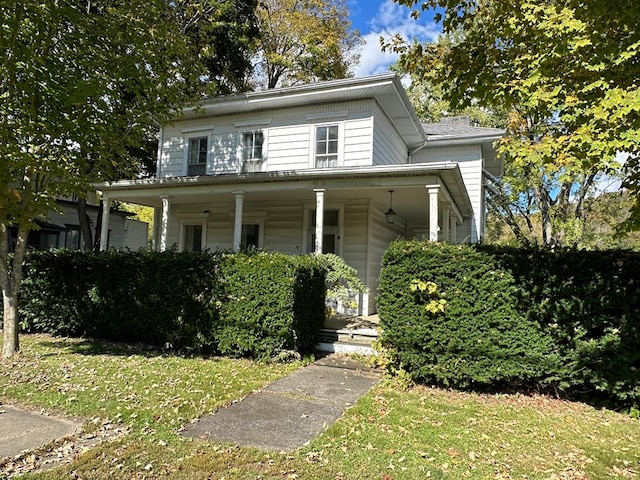 view of front of home featuring a front yard and a porch