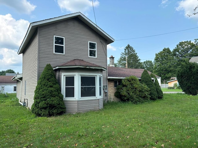 view of home's exterior with a yard